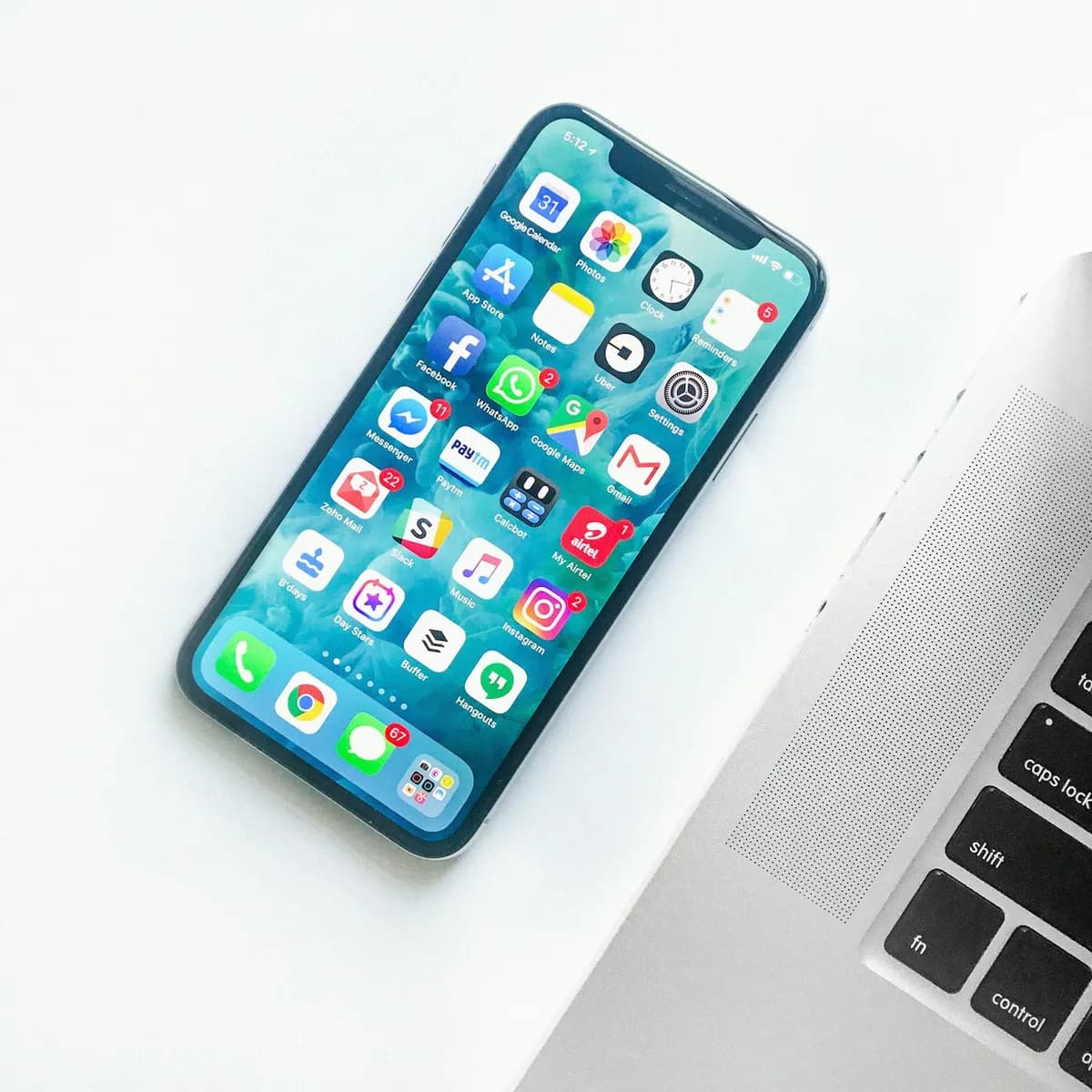 iPhone beside a MacBook during Siri Shortcuts development and on-device testing